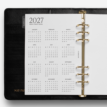 Black planner with a calendar page for 2027 on a white background